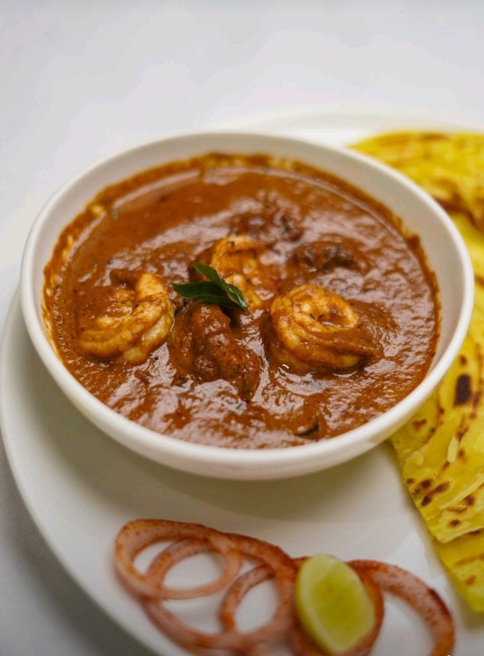 Sunlight filtering through the leaves of plants in a greenhouse.